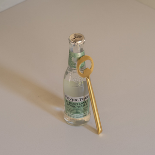 Lodhi Bottle Opener Leaning on Elderflower Tonic Bottle