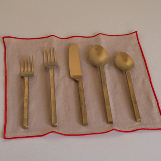 Lodhi Flatware Set On Top of Milia Napkin in Crimini