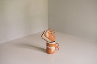 Nichols Mugs in Terracotta Splatter Stacked at a Tilt