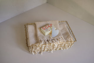 Antalya Waffle Towels Stacked in Akita Low Wire Basket with Sounds Banya Soap and Gua Sha