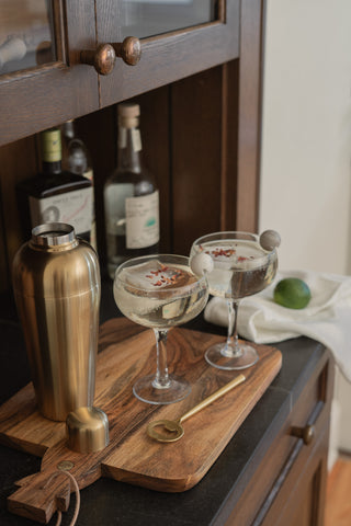 Manza Tea Towel in Leche on Built-In Bar with May Cocktail Shaker and Coupe Glasses on Bardwell Board