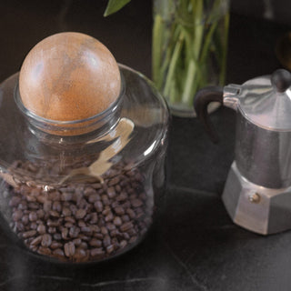 Yamuna Short Orb Canister with Coffee Beans Next to a Bialetti and Vase of Flowers