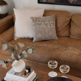 Taronga Square Pillow in Light Clay on Leather Sofa