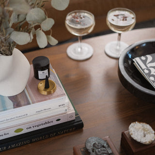 Tengu Round Incense Stand on Book Stack on Coffee Table with Rosalia Marble Bowl, Antique Decor, and Coupe Glasses