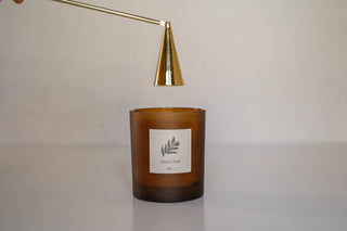 Slope Candle Douter Hovering Over Santal Noir Candle