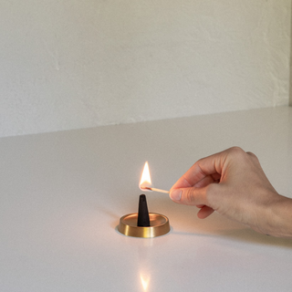 Basilic Vert No. 2 Incense Cone Being Lit on Tengu Round Incense Holder